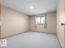 Neutral-toned walls complement the light gray carpeting and wood-finish trim - 