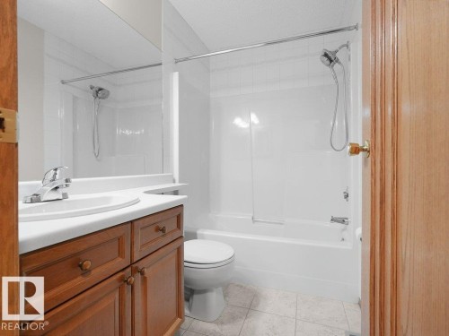 BAthroom located on the upper level. 4 pce. guest bathroom. Wood-finish vanity with white countertop, integrated sink, and chrome faucet - 535 Pardee Bay Nw, Edmonton, AB 