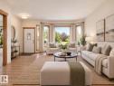 AI GENERATED PHOTO:Bay window with exterior views, wood-finish flooring, recessed lighting, white entry door with decorative glass, and contrasting wood trim - 535 Pardee Bay Nw, Edmonton, AB 