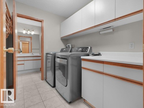 Laundry area with tile flooring, white cabinetry, and a countertop - 535 Pardee Bay Nw, Edmonton, AB 