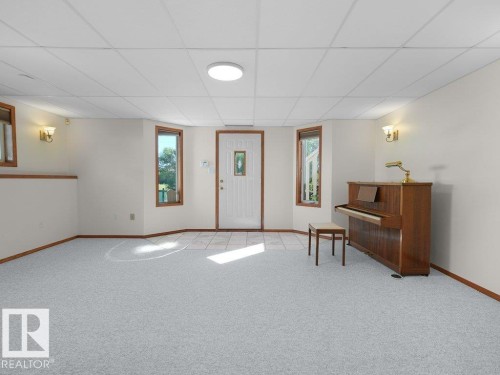 Walk -out basment - Recessed lighting, drop ceiling, wall sconces, tile flooring, and light-colored carpeting - 535 Pardee Bay Nw, Edmonton, AB 