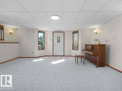 Walk -out basment - Recessed lighting, drop ceiling, wall sconces, tile flooring, and light-colored carpeting - 
