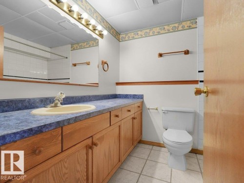 Extended vanity with laminate countertop, integrated basin, and full-width mirror - 535 Pardee Bay Nw, Edmonton, AB 