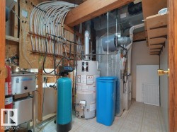 NO POLY B here, sellers just replaced with new Pex. Utility room with comprehensive mechanical systems including a water heater, furnace, and water filtration system - 