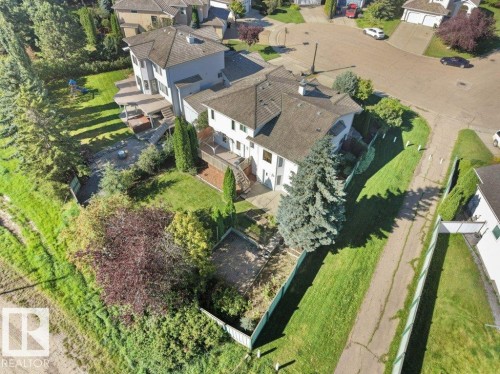 Property featuring a multi-level deck, mature trees, and a terraced lawn - 535 Pardee Bay Nw, Edmonton, AB 