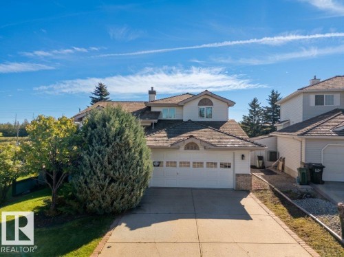 Two-story residence featuring a shingle roof, attached two-car garage, and a paved driveway with brick edging - 535 Pardee Bay Nw, Edmonton, AB 