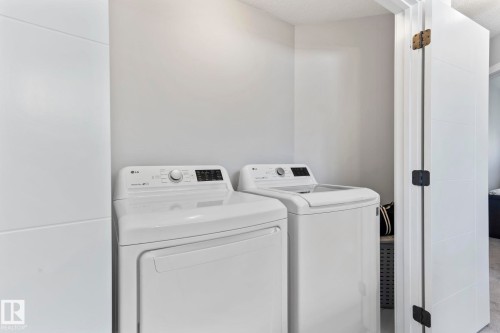 Dedicated laundry area with a white washer and dryer - 10338 162St Nw, Edmonton, AB 