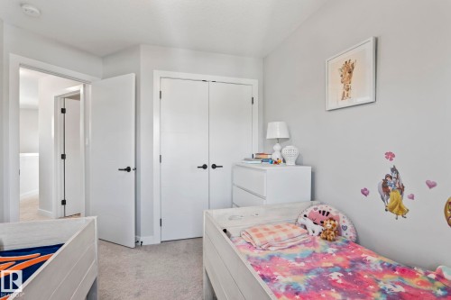 Light gray wall paint, white trim, white doors with black hardware, and gray carpeting - 10338 162St Nw, Edmonton, AB 