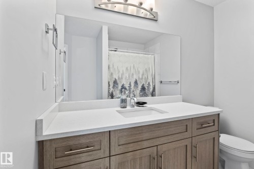 Wood-finish vanity with a white countertop and an integrated sink - 10338 162St Nw, Edmonton, AB 