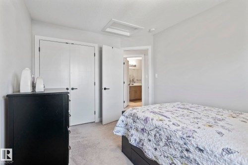 Carpeted flooring with light gray walls, white trim, and white interior doors with matte black hardware - 10338 162St Nw, Edmonton, AB 