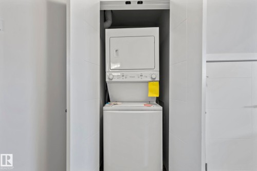 Stackable laundry appliances are housed in a dedicated alcove - 10338 162St Nw, Edmonton, AB 