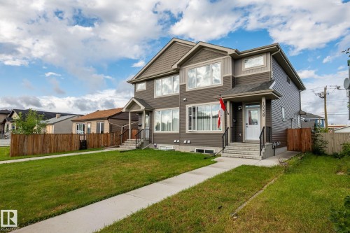 Multi-level exterior with dark siding, light trim, and prominent windows - 10338 162St Nw, Edmonton, AB 