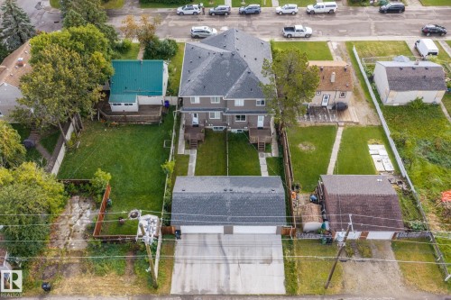 Two-story multi-unit structure with dark gray shingle roofing and individual rear decks - 10338 162St Nw, Edmonton, AB 