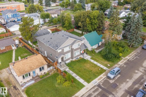 Two-story residence featuring a gray exterior, a paved walkway, and a landscaped front lawn - 10338 162St Nw, Edmonton, AB 