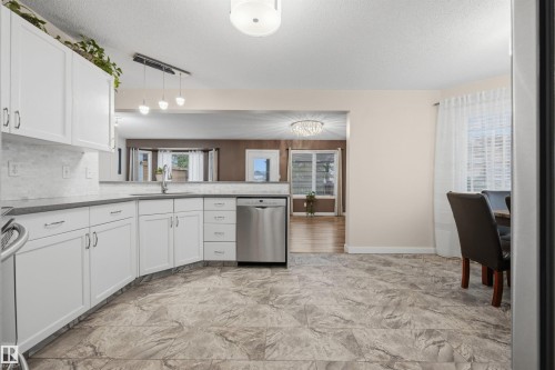 View of open-concept kitchen with updated appliances - 6910 158A Avenue Nw, Edmonton, AB 