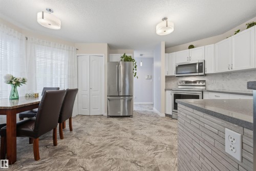 View of open-concept kitchen with breakfast area - 6910 158A Avenue Nw, Edmonton, AB 