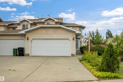 Front view of home with double attached garage and large driveway - 6910 158A Avenue Nw, Edmonton, AB 