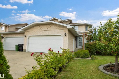 Front view of home with double attached garage and large driveway - 6910 158A Avenue Nw, Edmonton, AB 