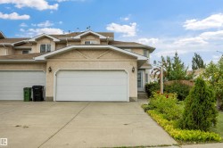 Front view of home with double attached garage and large driveway - 