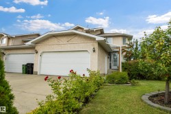 Front view of home with double attached garage and large driveway - 