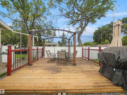 Expansive wooden deck with an arched pergola - 12002 48 Street Nw, Edmonton, AB 
