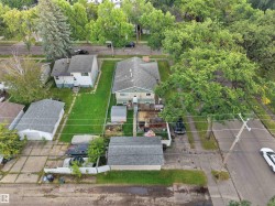 Detached garage structure, established landscaping, concrete driveway, and covered porch - 