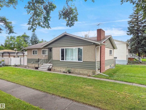 Exterior featuring a combination of stucco and horizontal siding - 12002 48 Street Nw, Edmonton, AB 