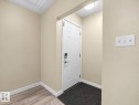 White paneled door with smart lock entry - 12002 48 Street Nw, Edmonton, AB 