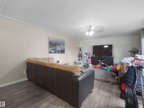Wood-finish flooring, crown molding, and a ceiling fan - 12002 48 Street Nw, Edmonton, AB 