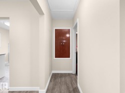 Wood-finish flooring with white trim and a recessed ceiling panel - 