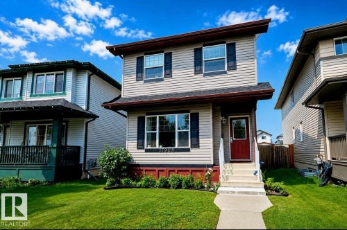 Two-story residence featuring light-colored siding, dark window shutters, and a contrasting dark red front door - 17908 89 Street Nw, Edmonton, AB - Outdoor With Deck Patio Veranda With Facade