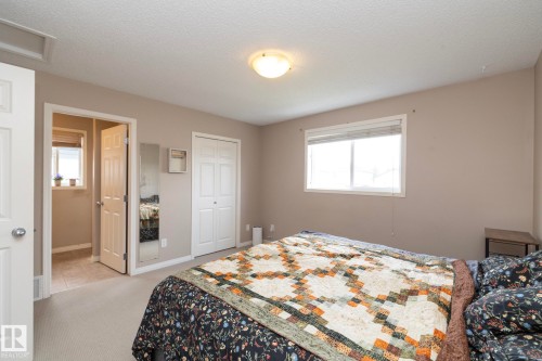 Bedroom featuring neutral-toned walls, a white window frame with blinds, and light-colored carpeting - 17908 89 Street Nw, Edmonton, AB - Indoor Photo Showing Bedroom