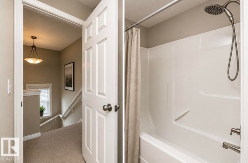 Functional bathroom featuring a white tub and shower combination with a brushed nickel showerhead and faucet - 17908 89 Street Nw, Edmonton, AB - Indoor Photo Showing Bathroom