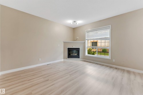 #27 13825 155 Av Nw, Edmonton, AB - Indoor Photo Showing Living Room With Fireplace