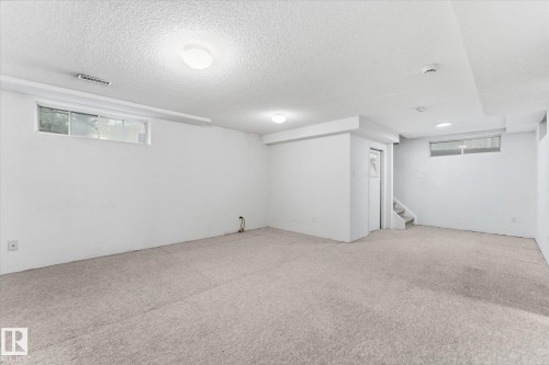 Carpeted flooring with white painted walls and ceiling - 11311 Malmo Road Nw, Edmonton, AB 