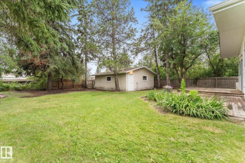 Expansive green lawn, mature trees, wood decking, garden landscaping, and detached outbuilding - 11311 Malmo Road Nw, Edmonton, AB 
