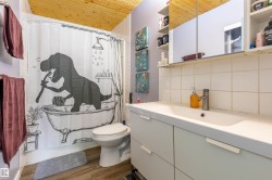 Bathroom featuring a full-width vanity with integrated sink, a wall-mounted medicine cabinet, and wood-finish flooring - 