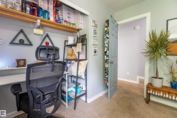 Dedicated workspace featuring built-in shelving, a neutral color palette, and carpeted flooring - 