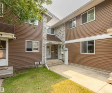 Multi-unit property with brown horizontal siding and stone veneer accents - 