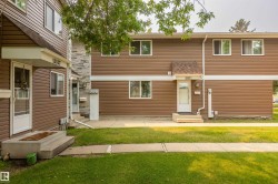 Townhouse exterior featuring brown horizontal siding and white trim - 