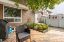 Expansive wood-finish deck with raised garden beds and a white privacy fence - 13323 47 Street Nw, Edmonton, AB  - Outdoor With Deck Patio Veranda With Exterior 