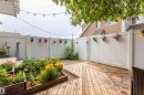 Expansive outdoor decking area featuring a multi-level design and a raised garden bed with established plantings - 13323 47 Street Nw, Edmonton, AB  - Outdoor With Deck Patio Veranda With Exterior 