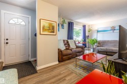 Light wood-finish flooring extends through the living area - 