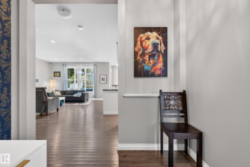 Hardwood-finish flooring extending through the living areas, white ceiling, and recessed lighting - 22933 94A Avenue Nw, Edmonton, AB 