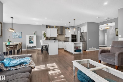 Open-concept living space with wood-finish flooring - 22933 94A Avenue Nw, Edmonton, AB 