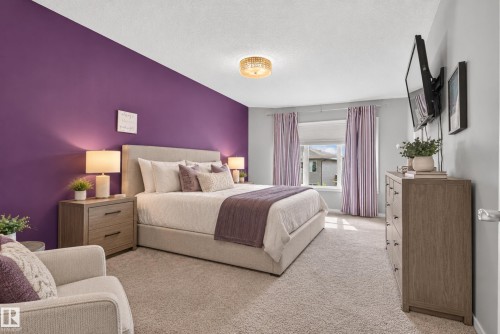Plush carpet flooring, a curved window, and recessed lighting create an inviting atmosphere - 22933 94A Avenue Nw, Edmonton, AB 
