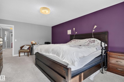 Recessed ceiling light fixture, accent wall, wall-mounted sconces, and carpeting - 22933 94A Avenue Nw, Edmonton, AB 