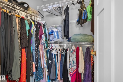 White wire shelving system with multiple hanging rods and storage shelves - 22933 94A Avenue Nw, Edmonton, AB 