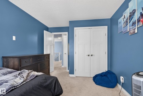 Wall-to-wall carpeting, paneled doors, and a built-in closet with double doors - 22933 94A Avenue Nw, Edmonton, AB 