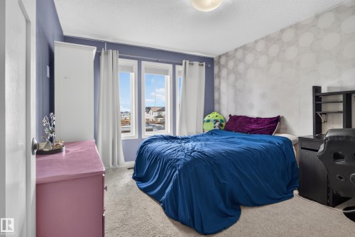 Recessed window with three panes, white window trim, and light-toned curtains - 22933 94A Avenue Nw, Edmonton, AB 